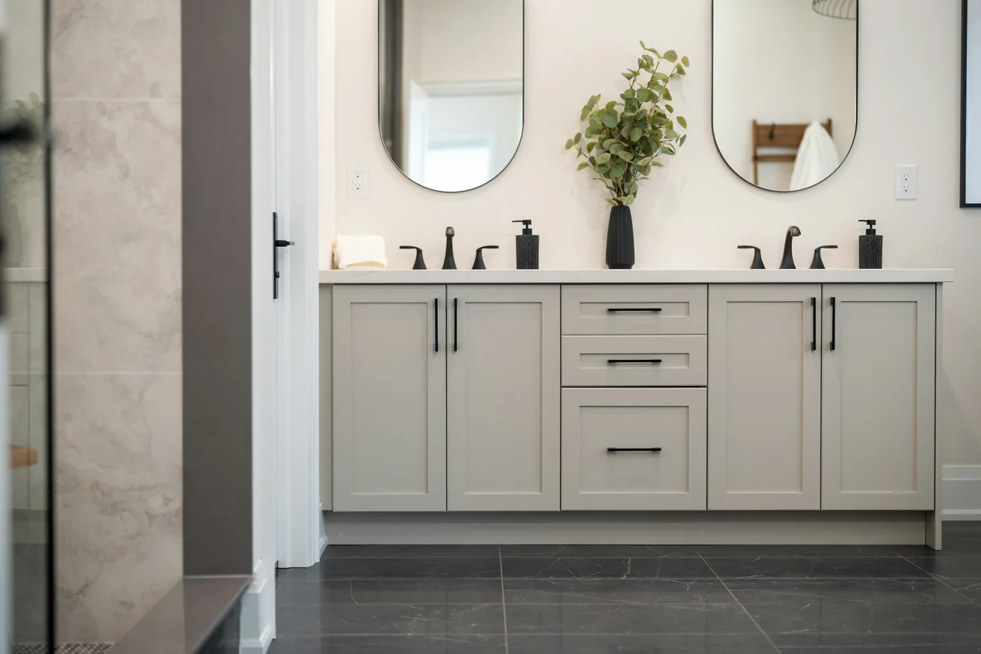 Bathroom inspiration with a double vanity, paired mirrors and simple dark fixtures