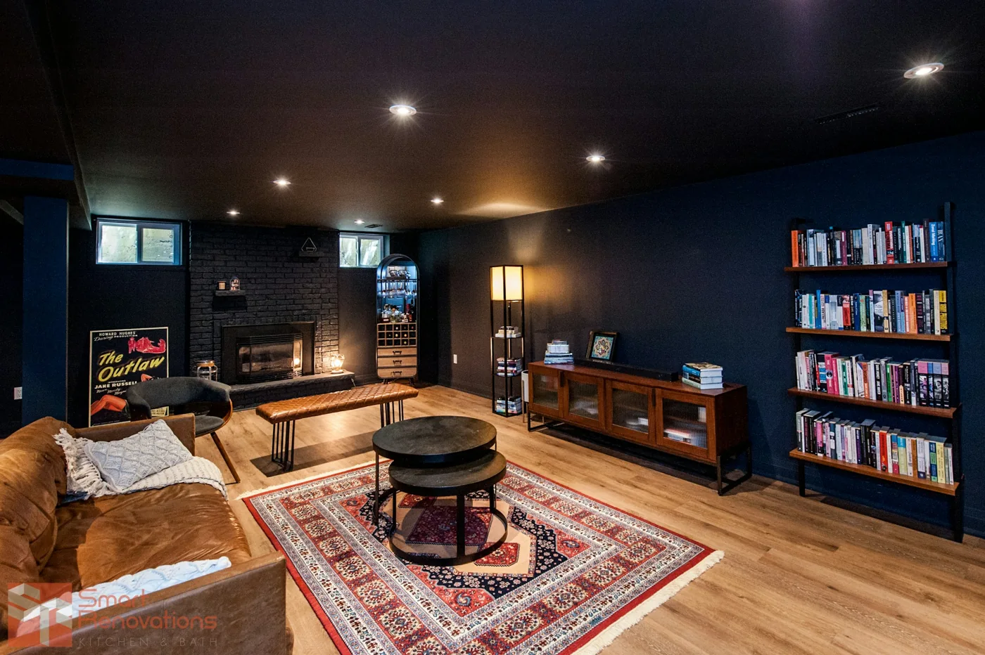 Basement lounge inspiration with bookshelves, a seating area and layered lighting