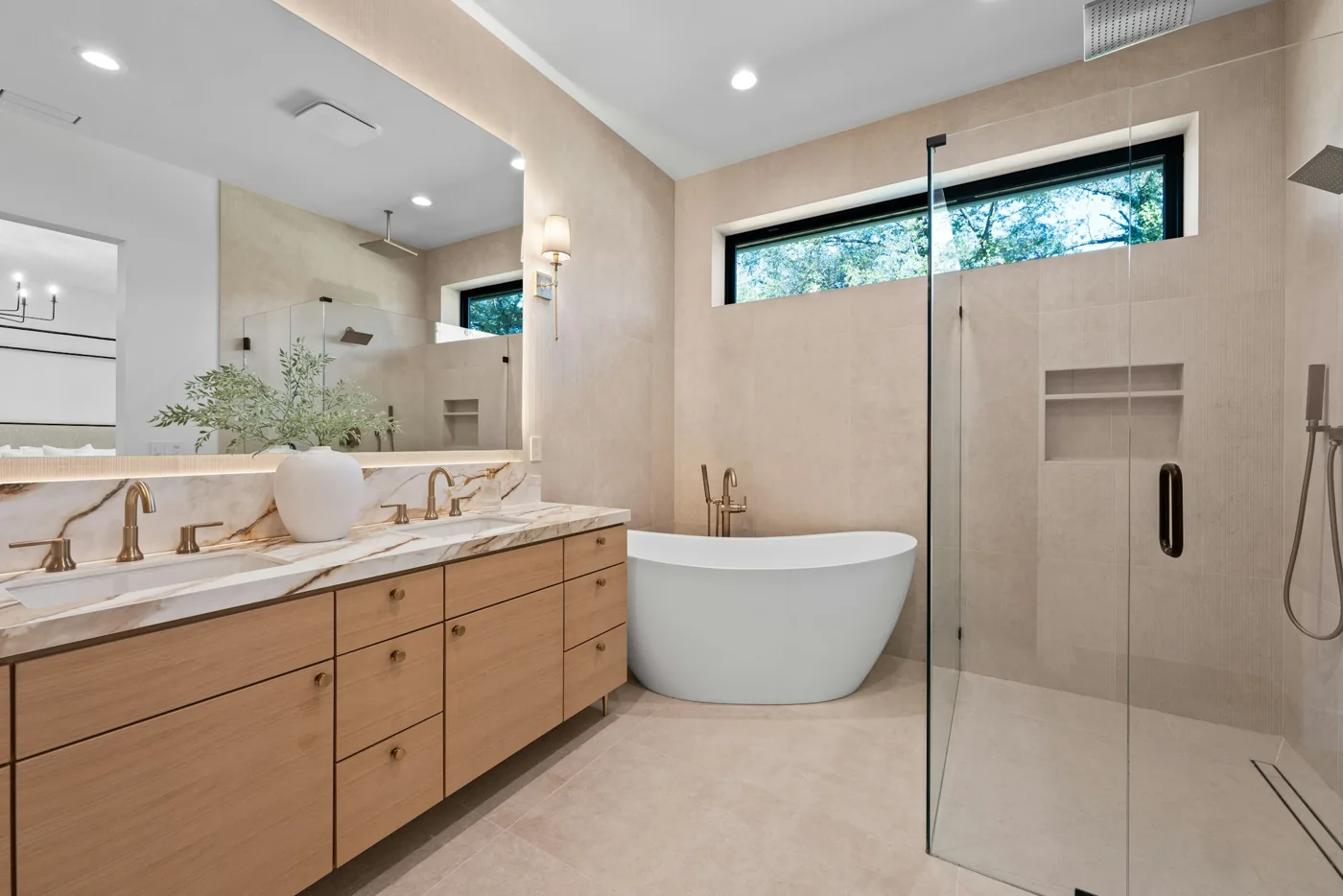 Bathroom design inspiration with an oak double vanity, freestanding bathtub and glass shower